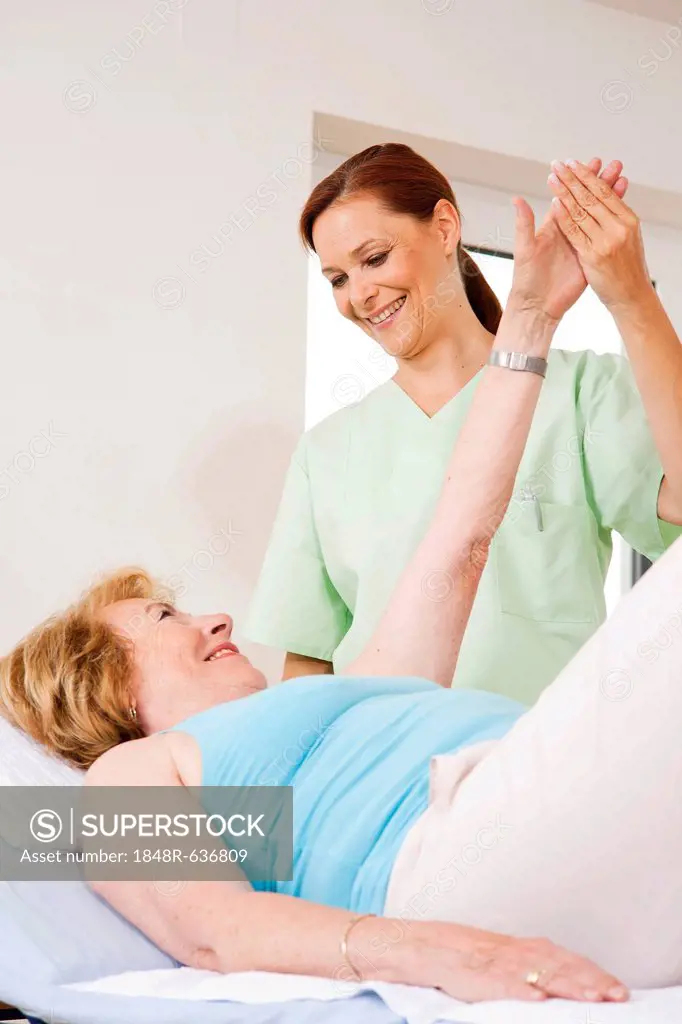 Patient being treated on her arm by a physiotherapist