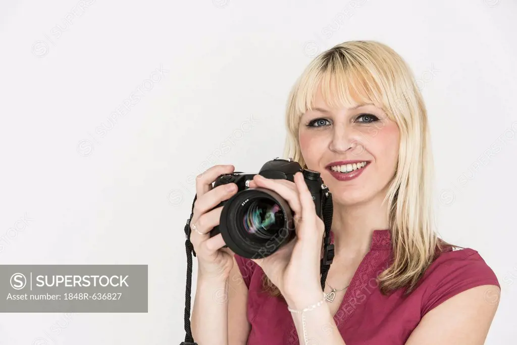 Young woman holding a SLR camera