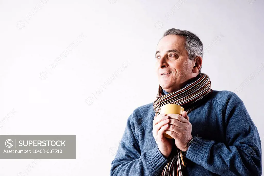 Elderly man holding a cup of tea