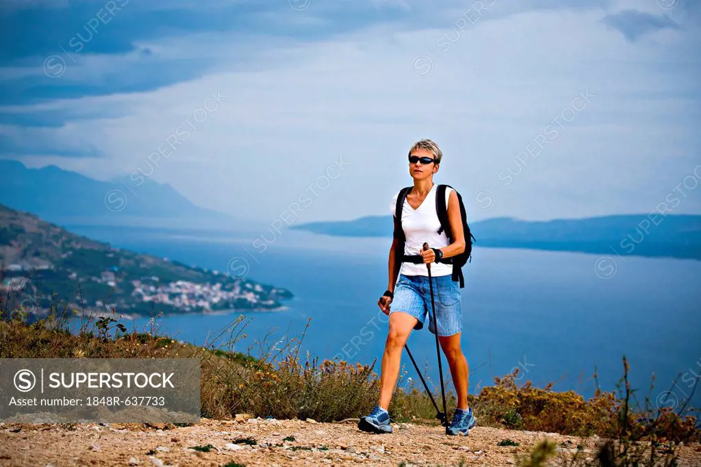 Woman hiking at the seaside, Omis, Adriatic coast, Croatia, Europe
