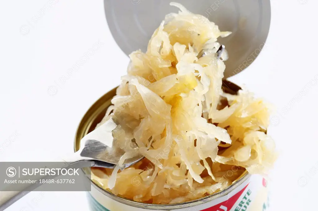 Open can of sauerkraut with a fork