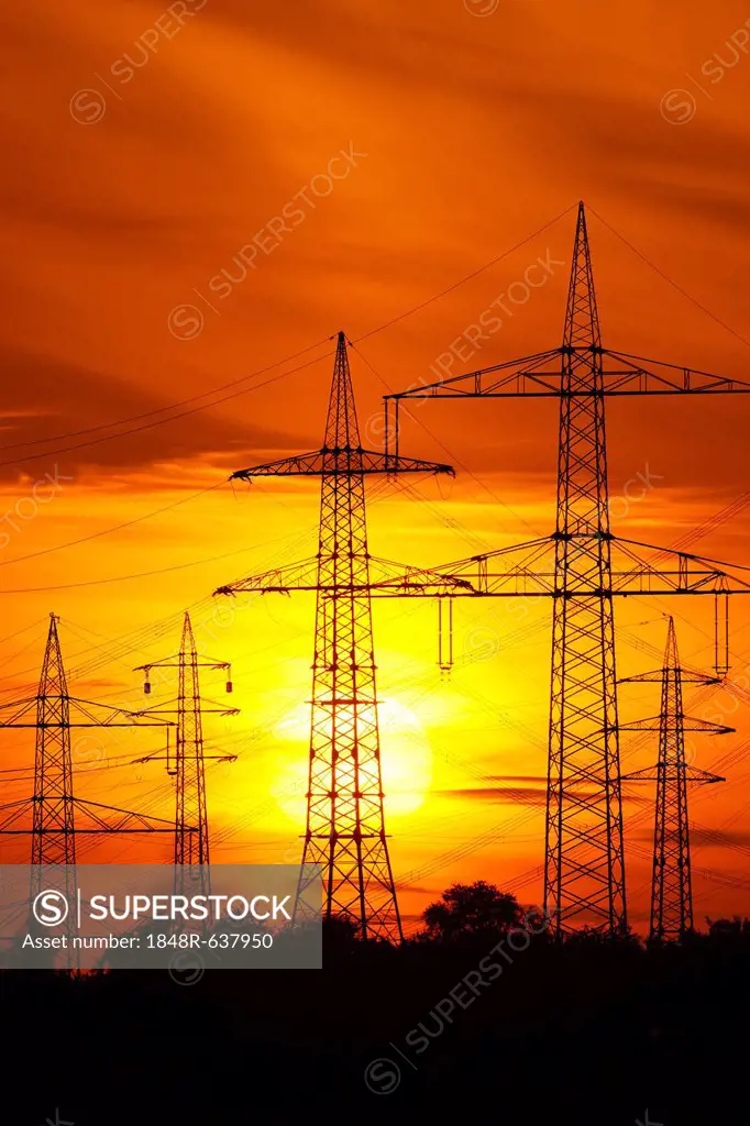 Transmission lines, overhead line towers, with setting sun, Beinstein in Stuttgart, Baden-Wuerttemberg, Germany, Europe