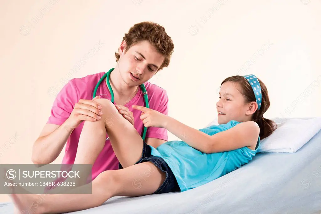 Girl having her knee examined by her pediatrician