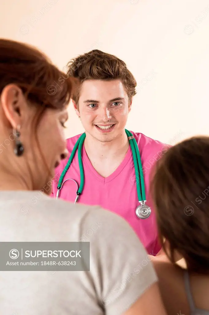 Mother and daughter talking with a pediatrician during an examination