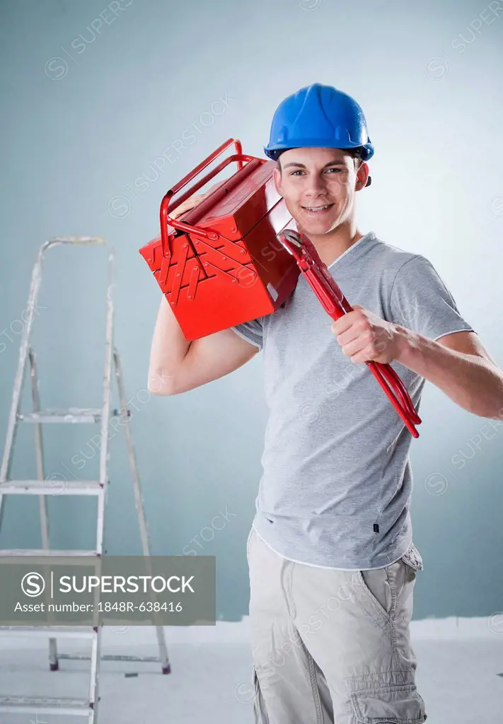 Young craftsman holding a tool box