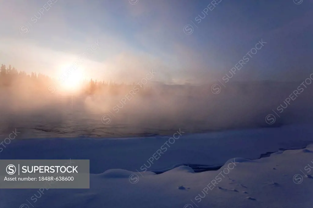 Ice fog, steam, mist over partly frozen Yukon River, Whitehorse, Yukon Territory, Canada