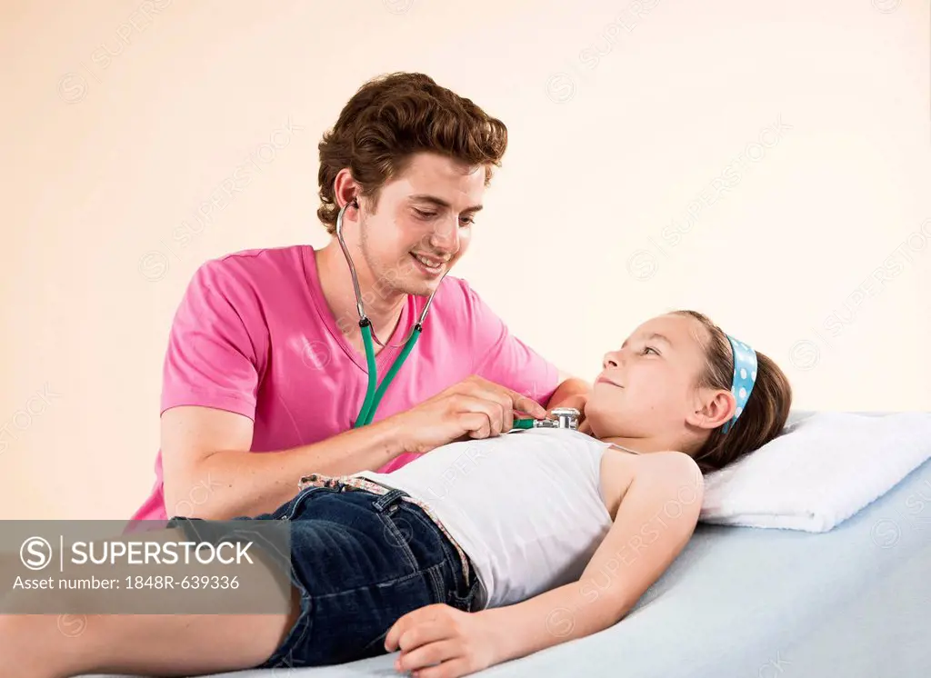 Girl being examined by her pediatrician with a stethoscope