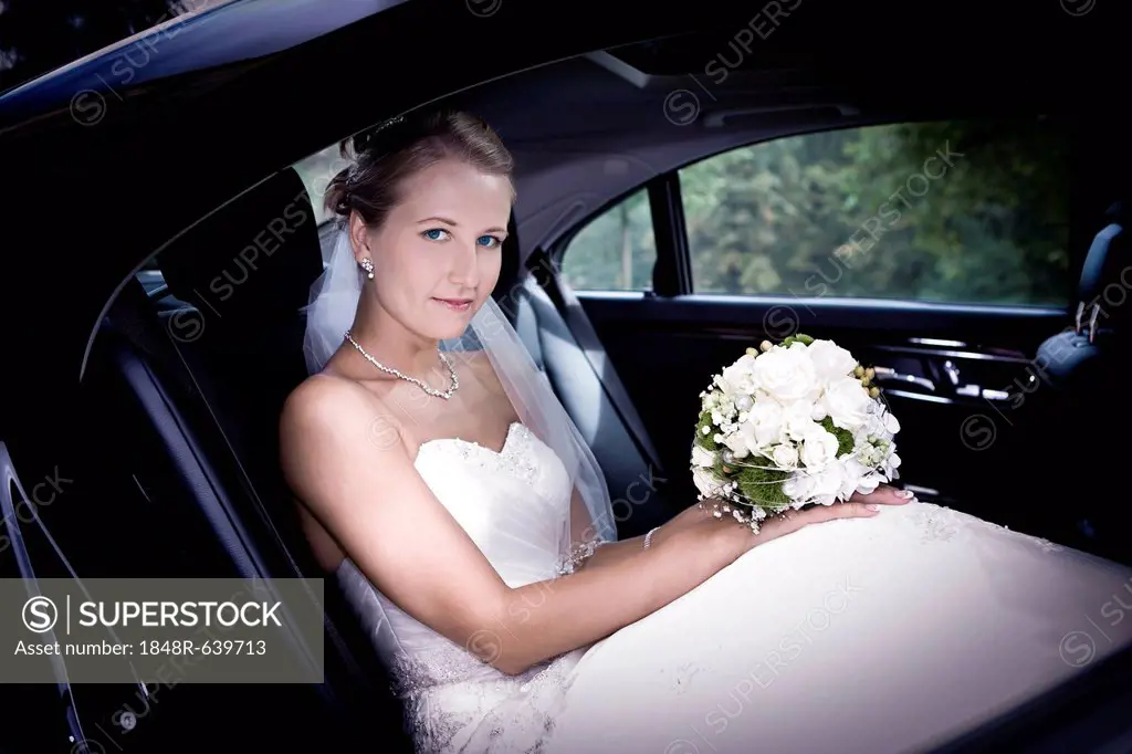 Young bride in a car