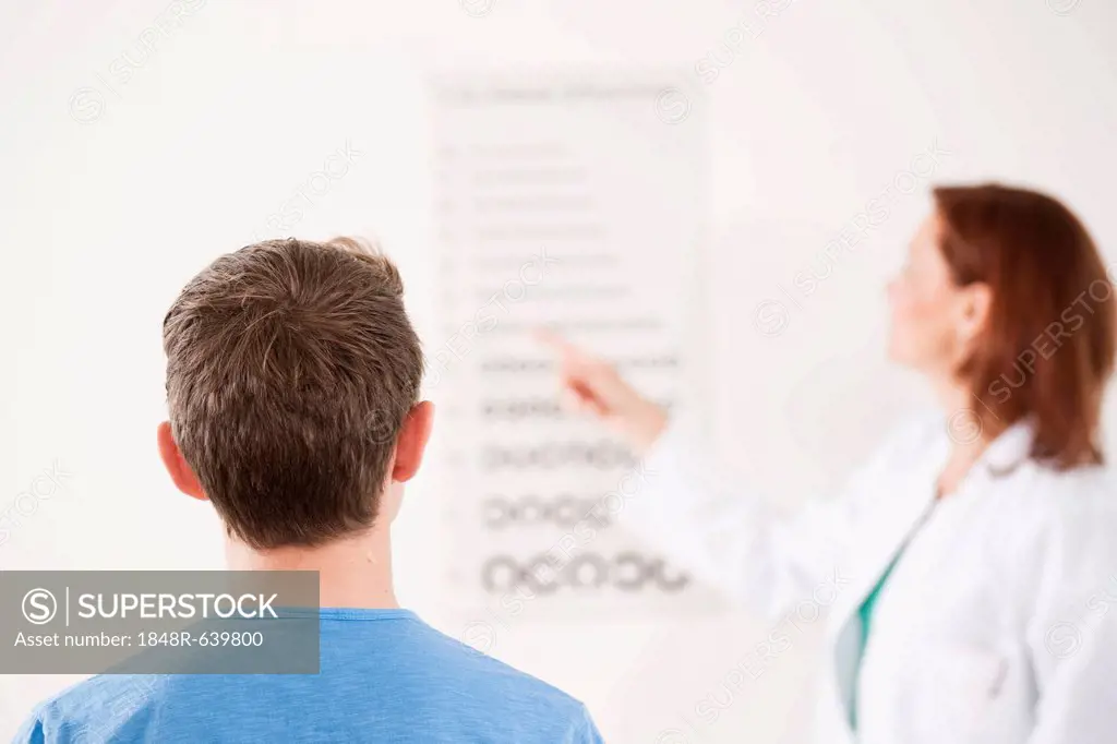 Teenage boy completing an eyesight test with an ophthalmologist