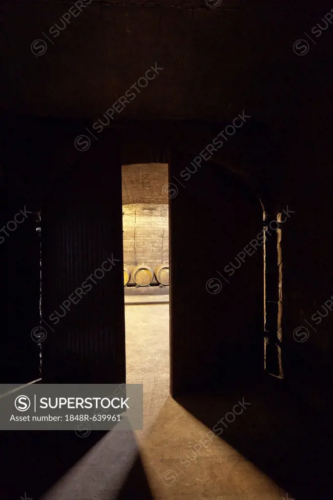 Looking through an open door into a wine cellar