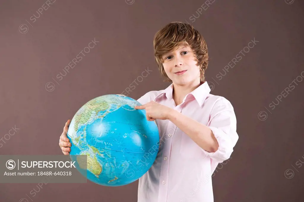 Boy holding a globe in his hands