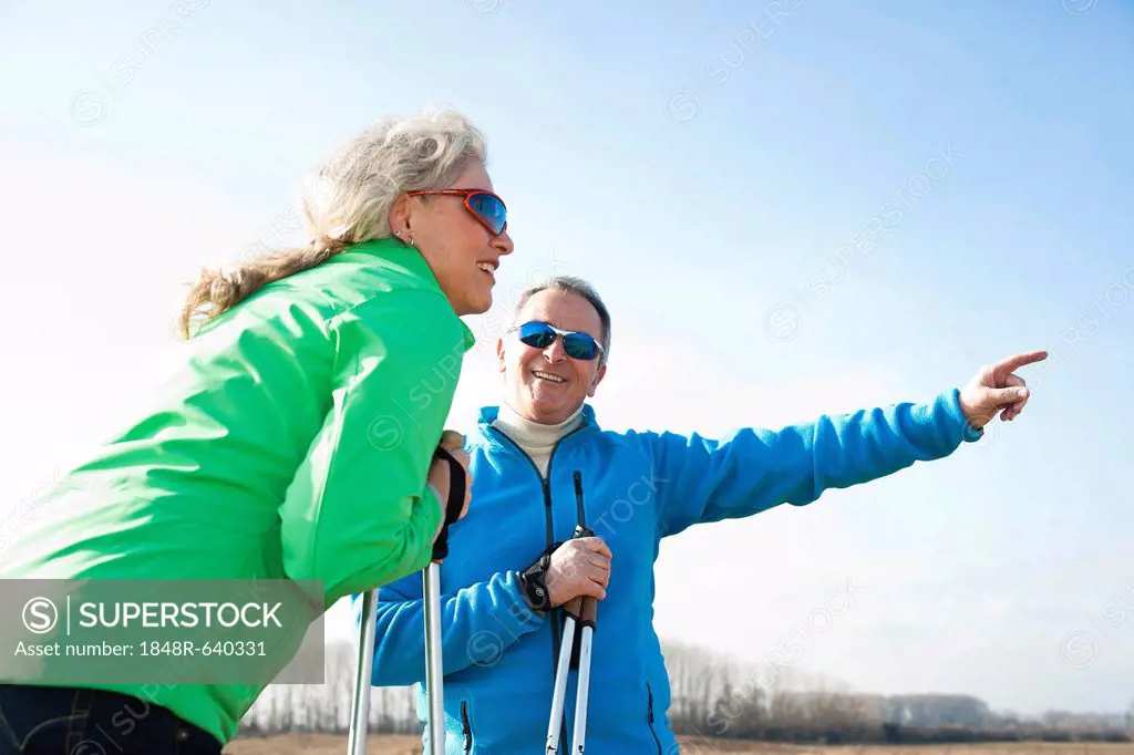Senior couple taking a break during Nordic walking