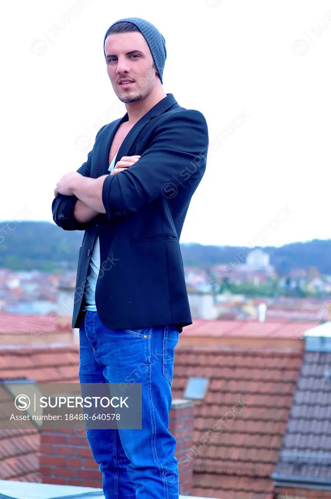 Young Italian man above the rooftops of Stuttgart, Baden-Wuerttemberg, Germany, Europe