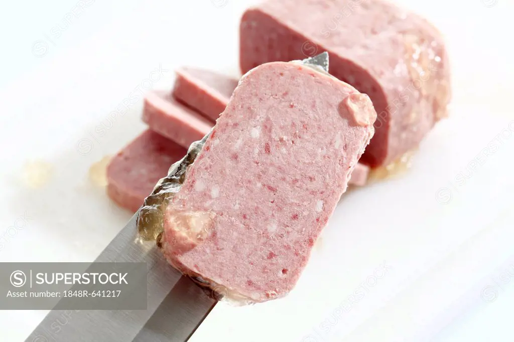 Cut spam in a can, one slice on a knife