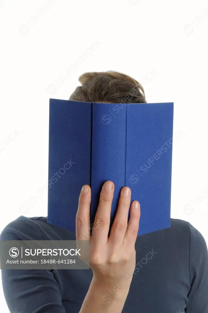 Woman with a blue book in front of her face