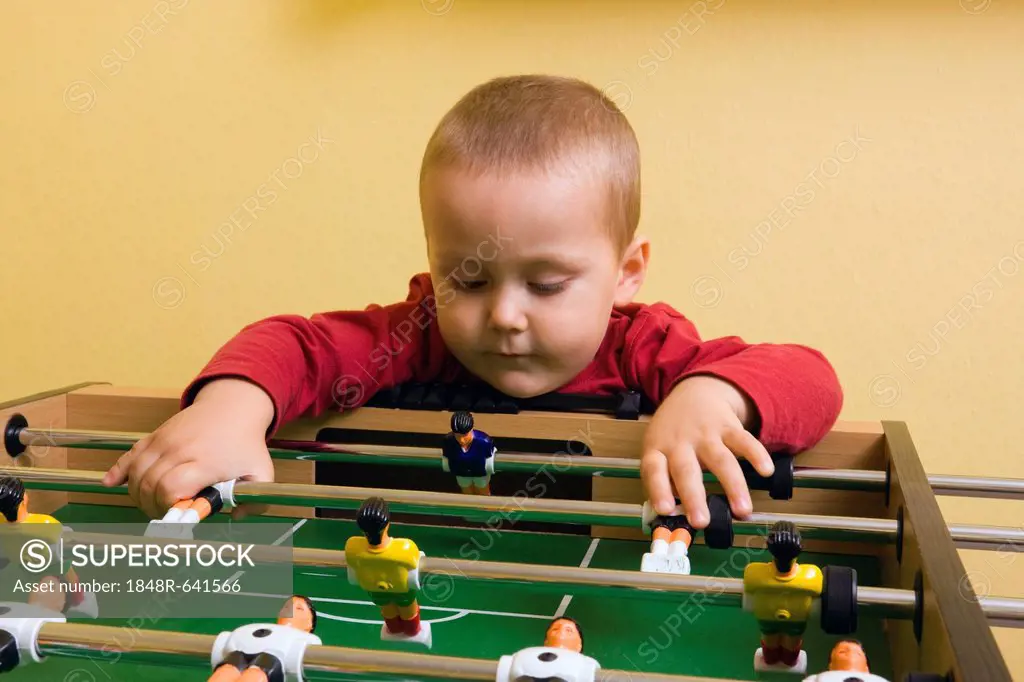 Boy, 2 years, playing with tabletop soccer