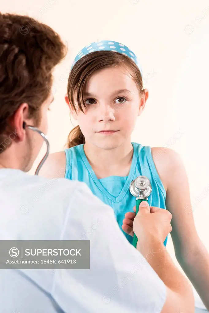 Girl being examined by her pediatrician with a stethoscope