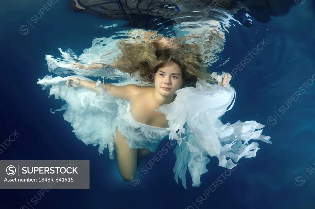 Woman presenting underwater fashion in pool, Odessa, Ukraine, Eastern Europe