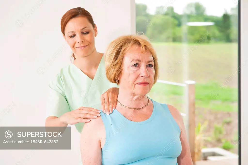 Patient being treated on her shoulder by a physiotherapist