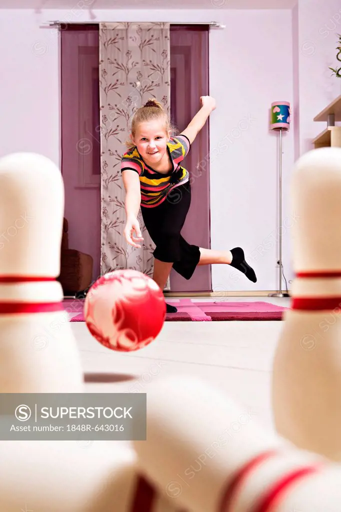 Girl playing bowling at home