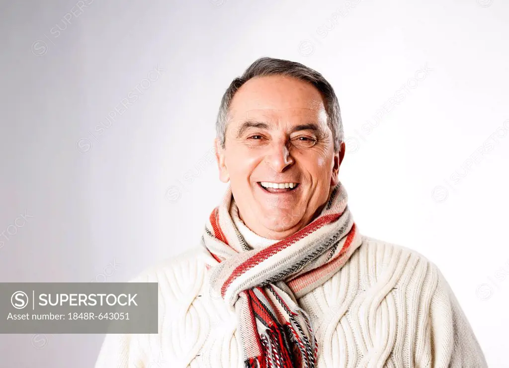 Laughing elderly man wearing a scarf