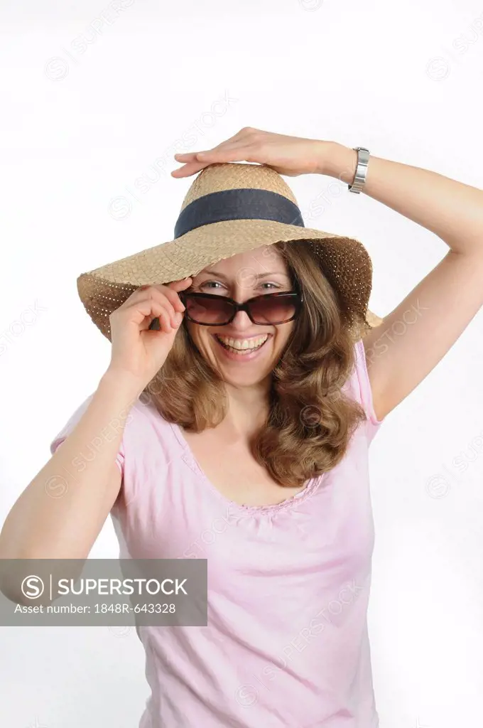 Young woman with sunglasses and a straw hat