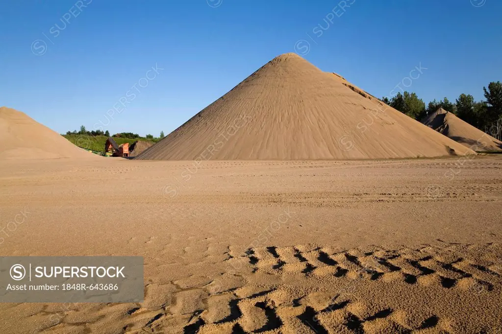 Tire tracks and mounds of sand in a commercial sandpit, Quebec, Canada