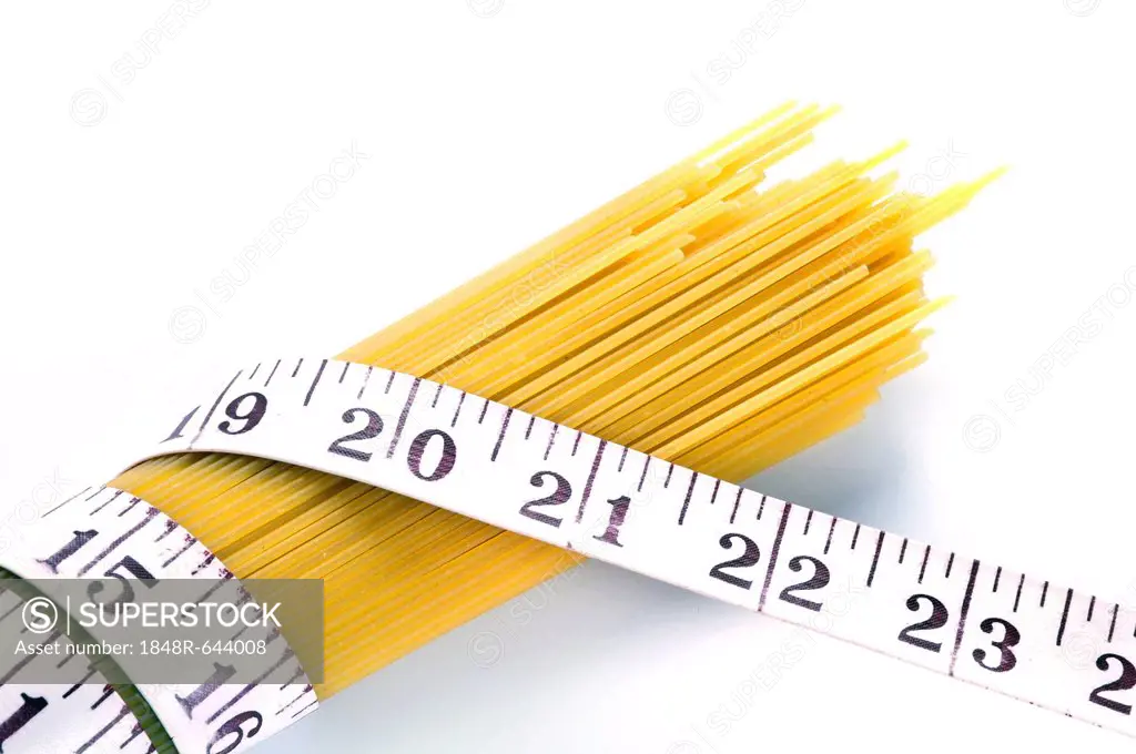 Spaghetti with a measuring tape, symbolic image