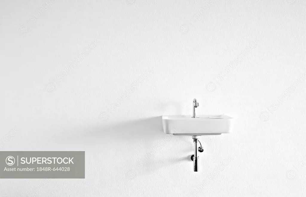 Sink on the wall in an empty room