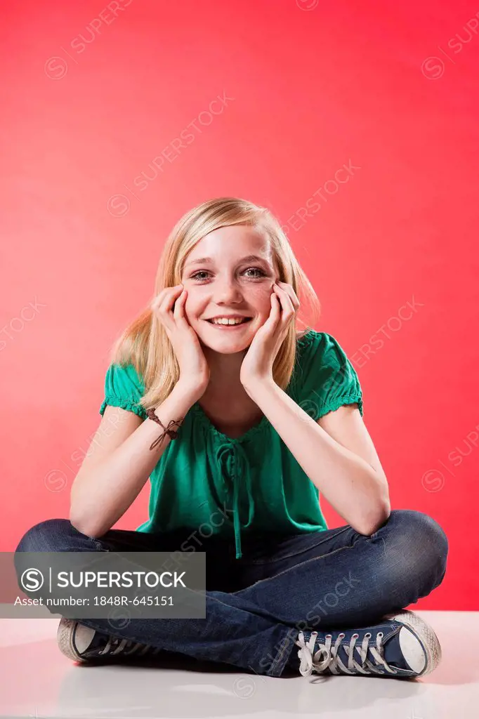 Smiling girl sitting cross-legged