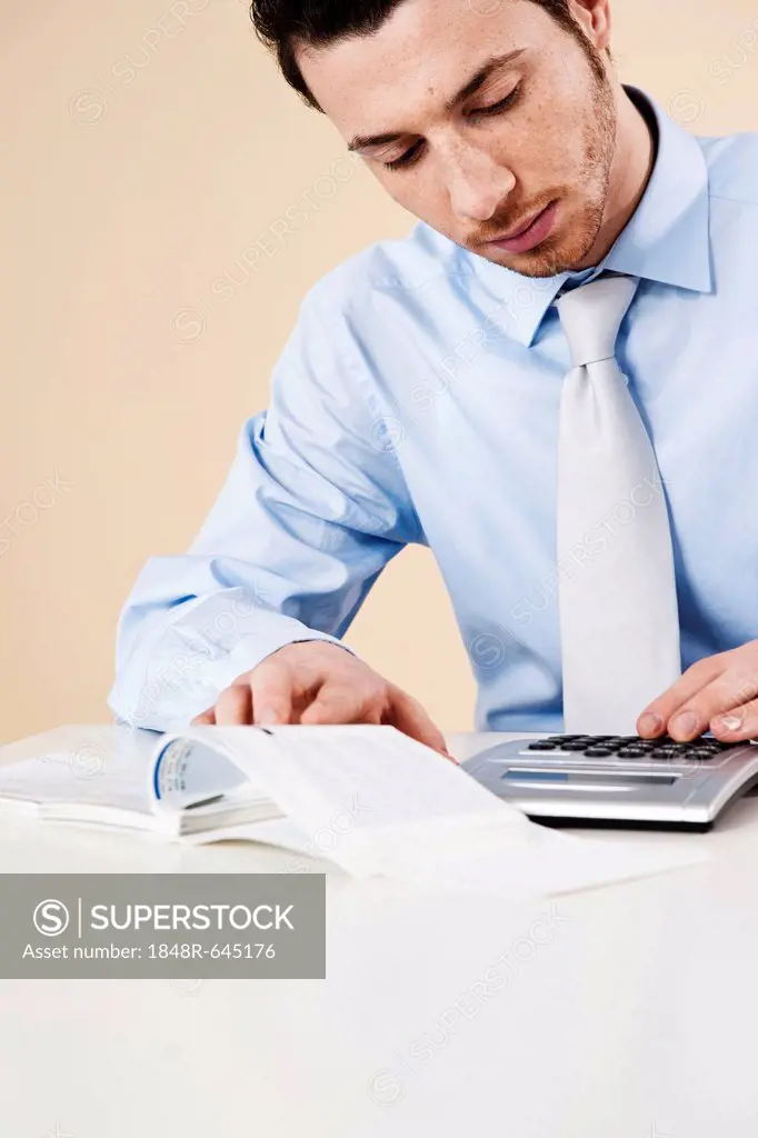 Young man checking his bank statements