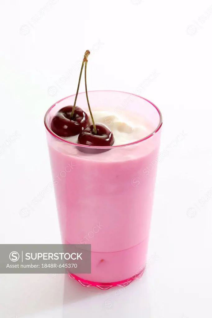 Pink cup with yoghurt and cherries
