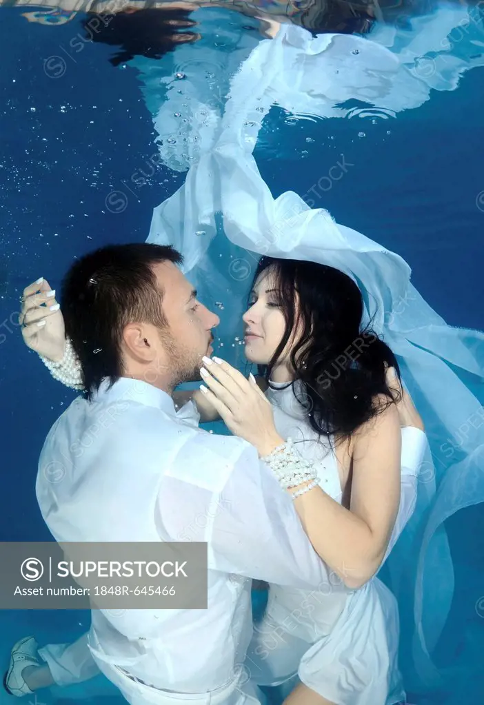 Bride and groom, underwater wedding in a pool