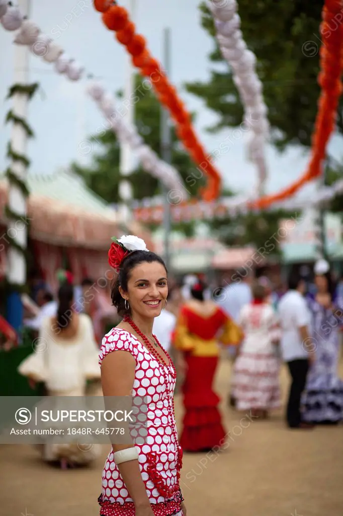 Young woman wearing a flamenco dress at the Feria de Abril April Fair in Seville, Andalucia, Spain, Europe