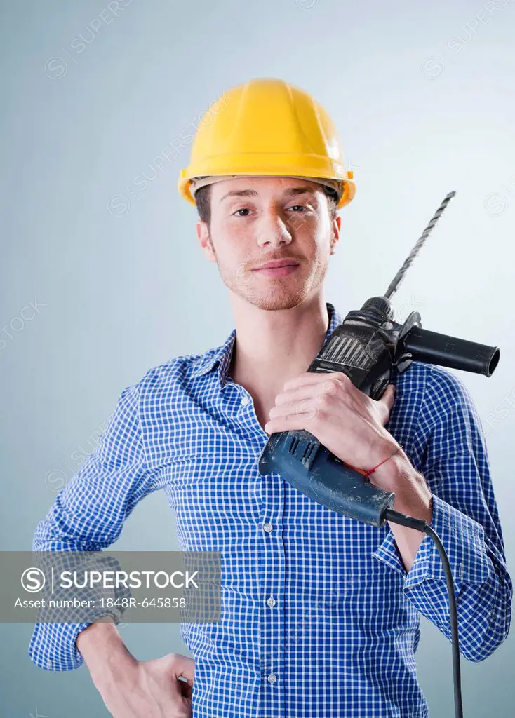Young craftsman holding a drill