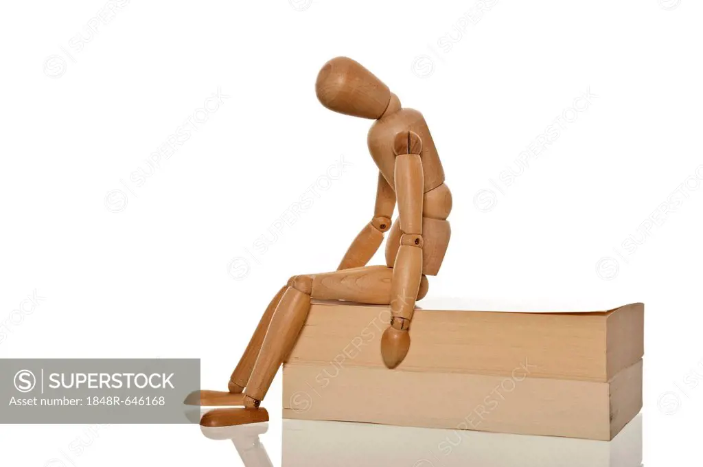 Mannequin looking desperate and exhausted while sitting on two books