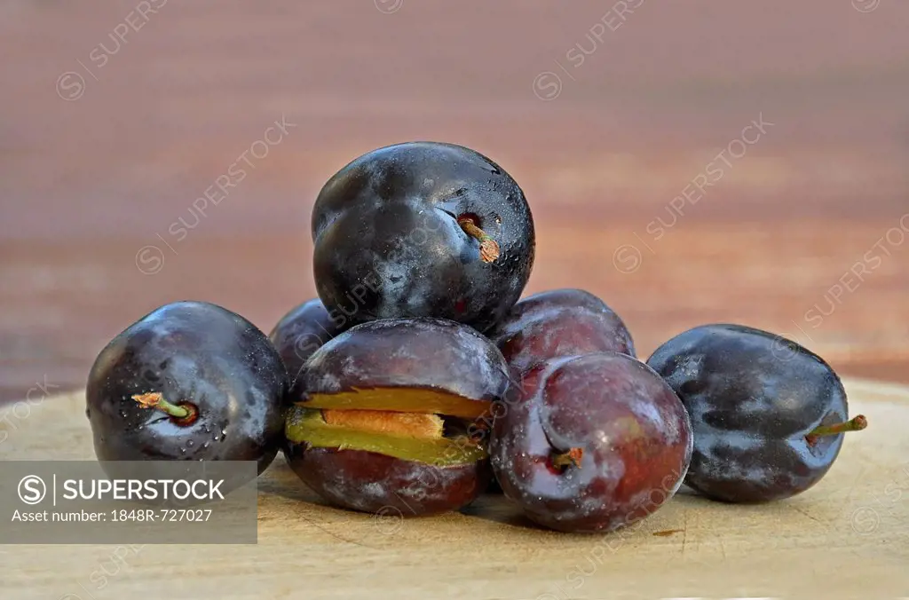Fresh plums on a wooden board