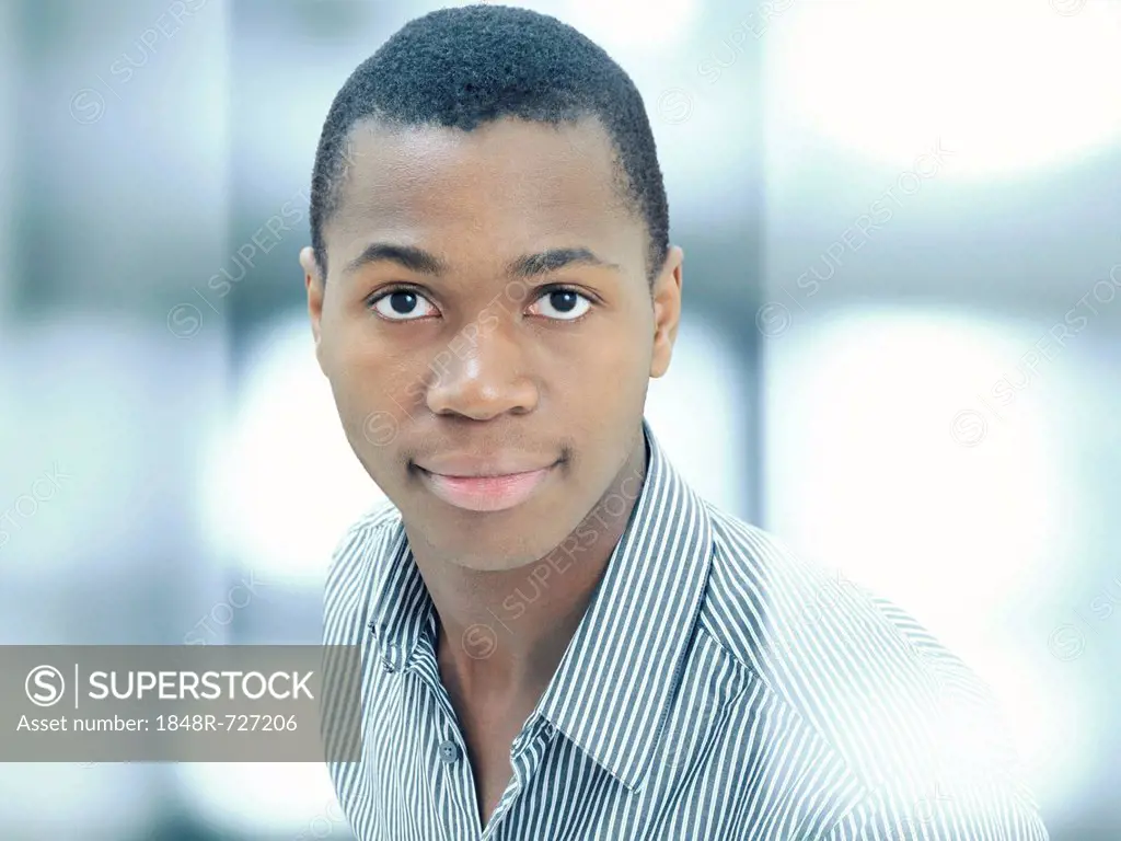 Young man, African-American, American, serious face, respectable, standing behind glass