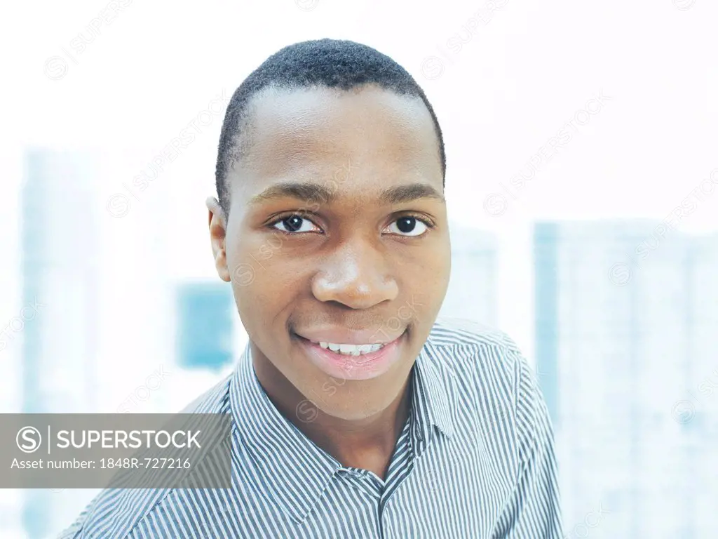 Man, businessman, young, African-American, American, friendly, smiling, confident, successful, in front of a city skyline