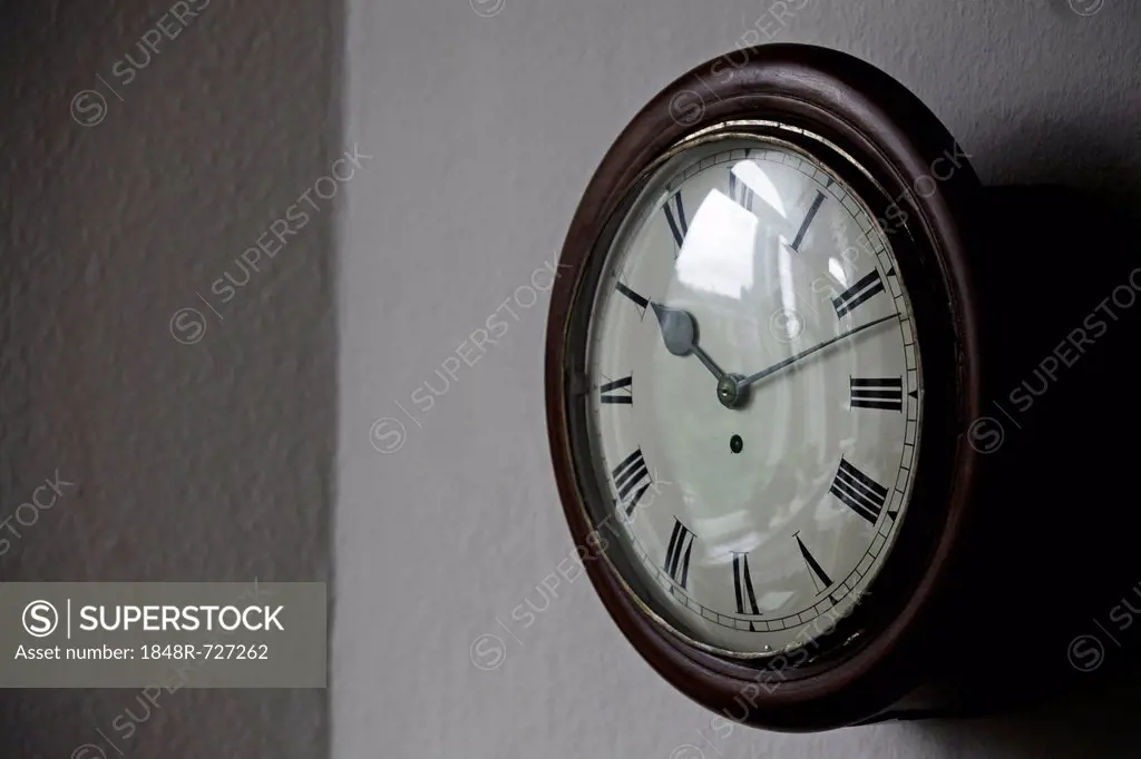 Antique wall clock, dial with Roman numerals