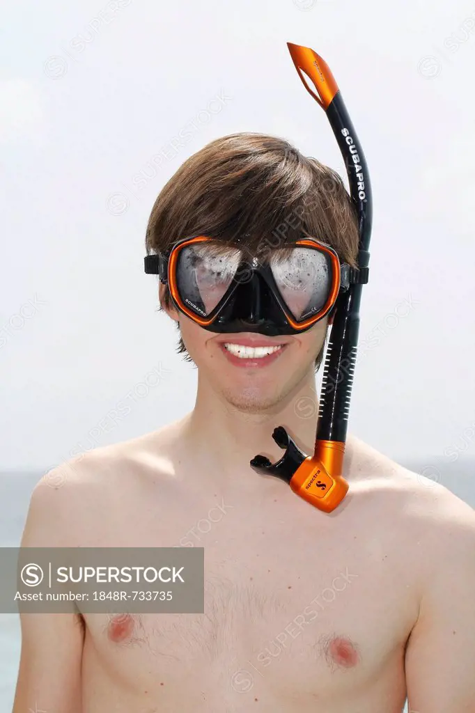 Young man wearing snorkel and diving goggles, Maldives, Indian Ocean
