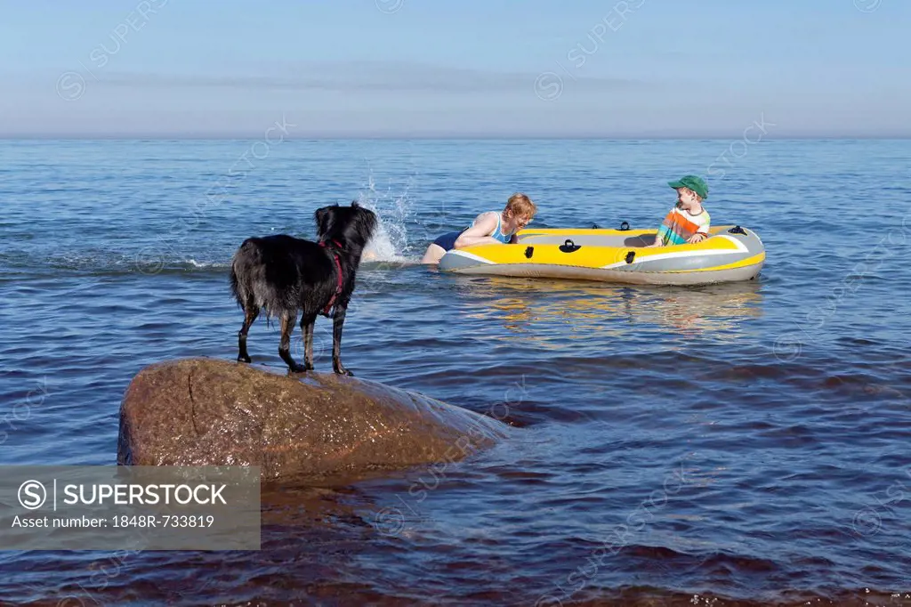 Mother and son in a rubber boat, dog watching, Kuehlungsborn-West, Mecklenburg-Western Pomerania, Germany, Europe