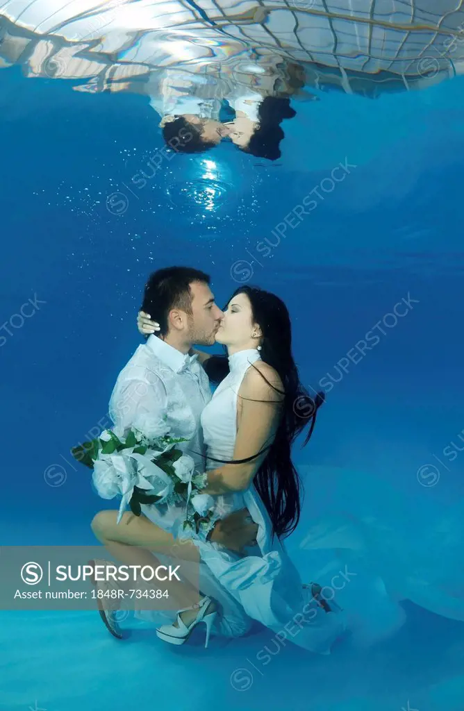 Bride and groom, underwater wedding in a pool