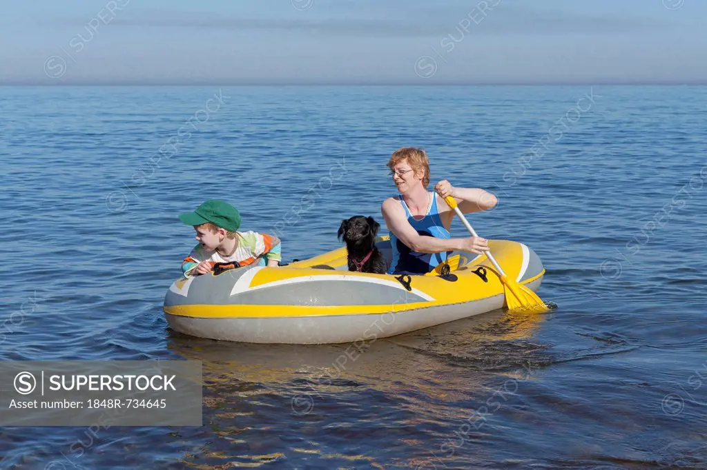 Mother and son with dog in a rubber boat, Kuehlungsborn-West, Mecklenburg-Western Pomerania, Germany, Europe