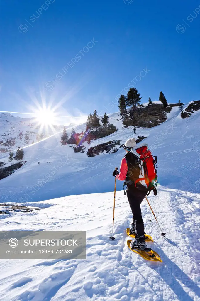 Snowshoe walker during the ascent to Martell hut, Martell valley, above Zufallhuette hut, South Tyrol, Italy, Europe