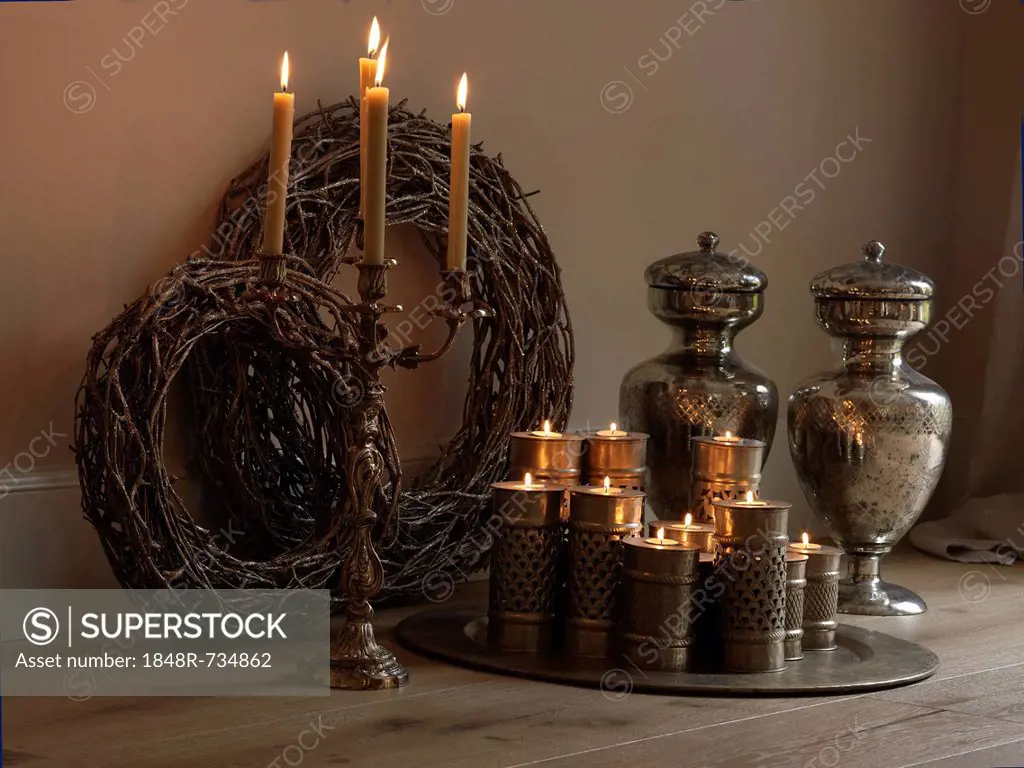 Decorative still life with candles in silver candlesticks