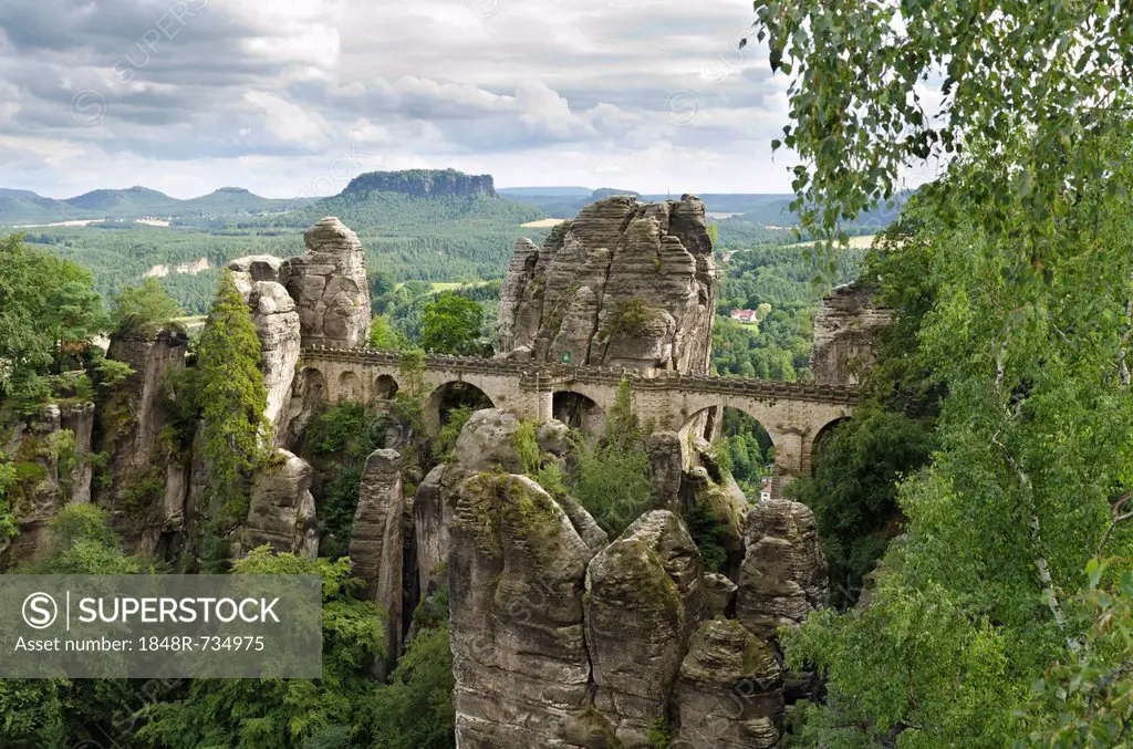 View of the rocks of the Bastei and the Basteibruecke bridge, behind Mt. Lilienstein, Elbe Sandstone Mountains, Saxony, Germany, Europe