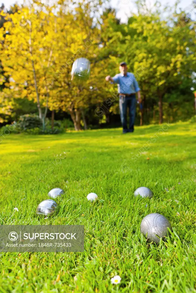Man tossing a ball while playing boules, petanque, Hesse Germany, Europe