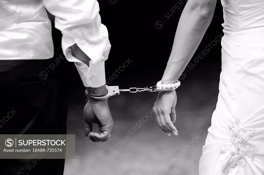 Wedding, bride and groom with handcuffs