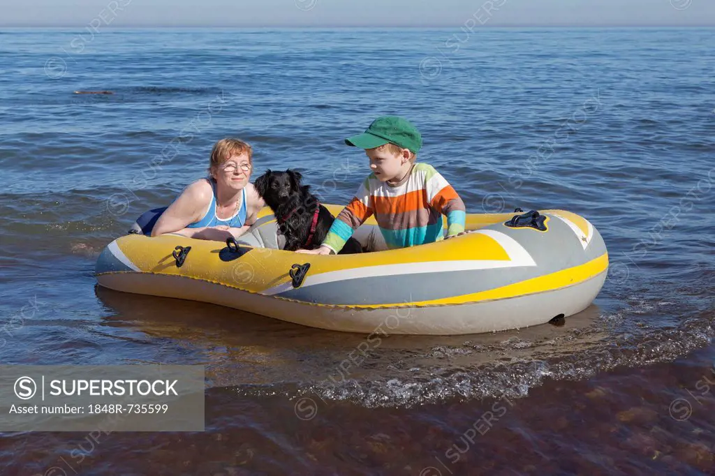 Mother and son with dog in a rubber boat, Kuehlungsborn-West, Mecklenburg-Western Pomerania, Germany, Europe